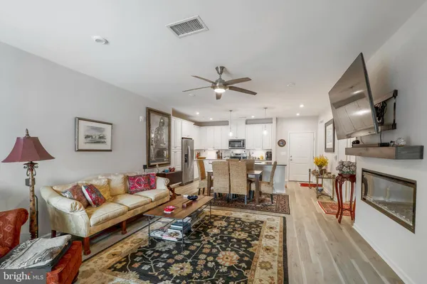 a living room with furniture and kitchen view