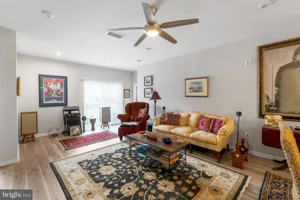 a living room with furniture rug and a flat screen tv