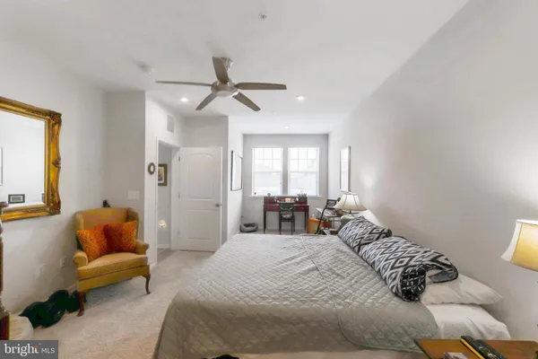 a bedroom with a bed a couch and a window