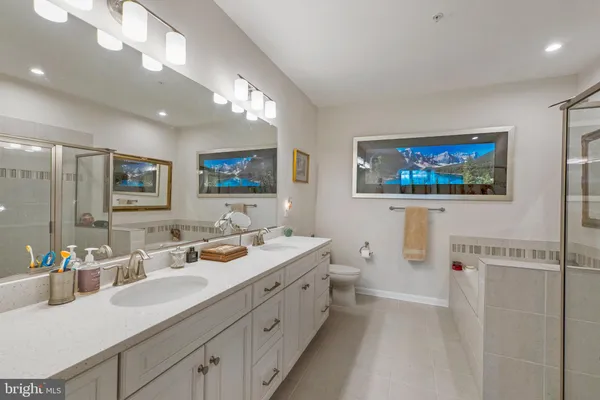 a bathroom with double vanity sink and a mirror