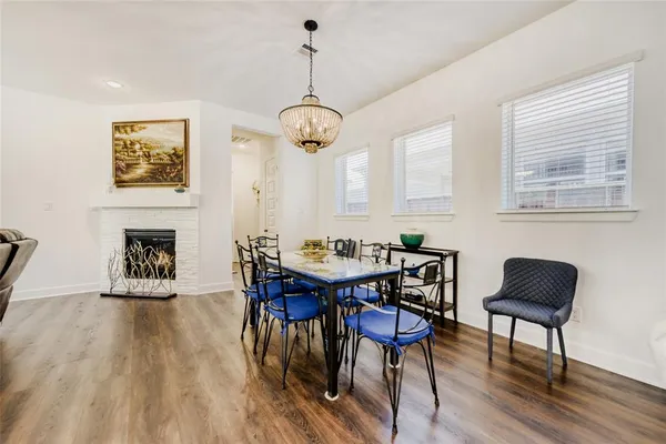 a view of a dining room with furniture wooden floor and a chandelier