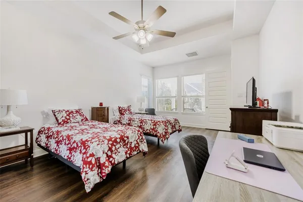 a bedroom with two beds and a large window