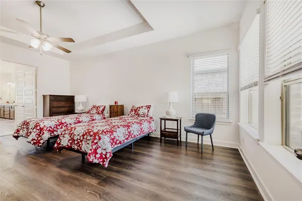 a bedroom with furniture and a wooden floor