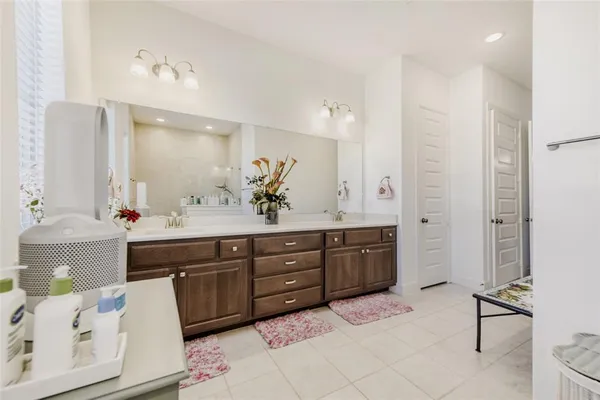a spacious bathroom with a granite countertop sink and a mirror