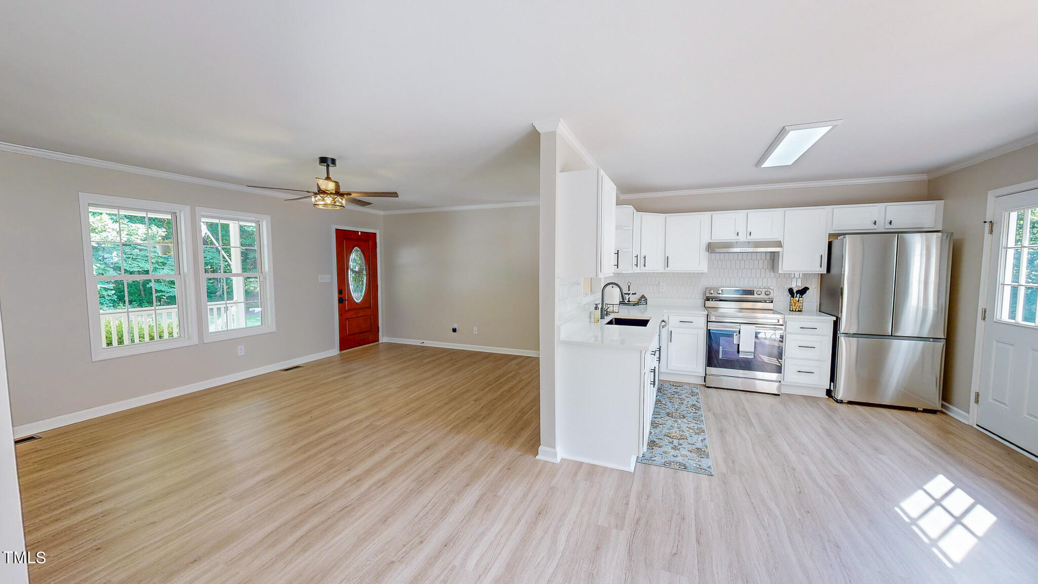 137 Dandelion Drive Timberlake, NC 27583 - Photo 12 of 53 a kitchen with stainless steel appliances a refrigerator sink and wooden floor