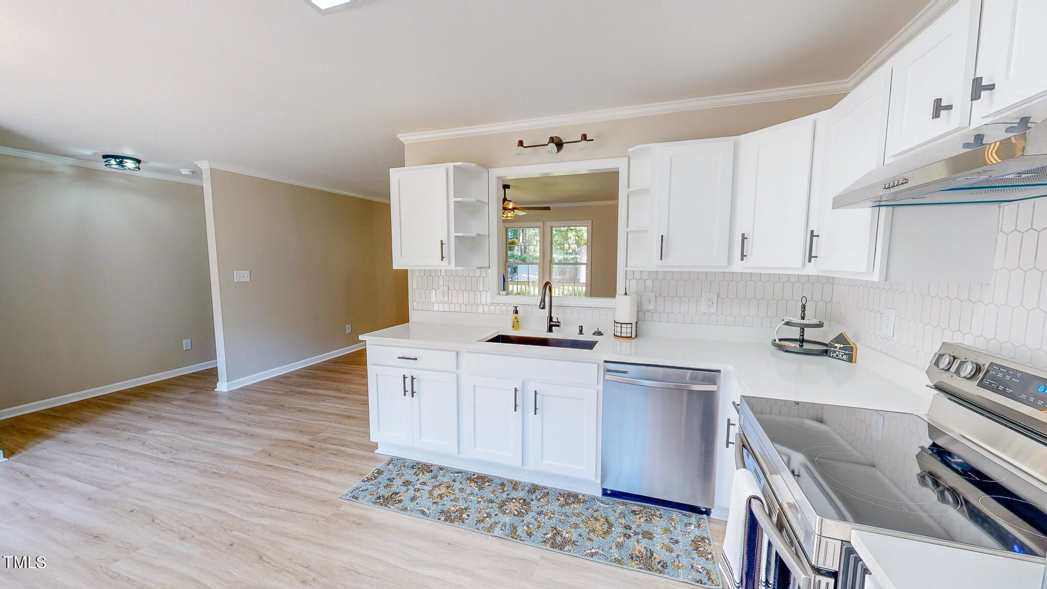 137 Dandelion Drive Timberlake, NC 27583 - Photo 15 of 53 a kitchen with a sink cabinets and wooden floor
