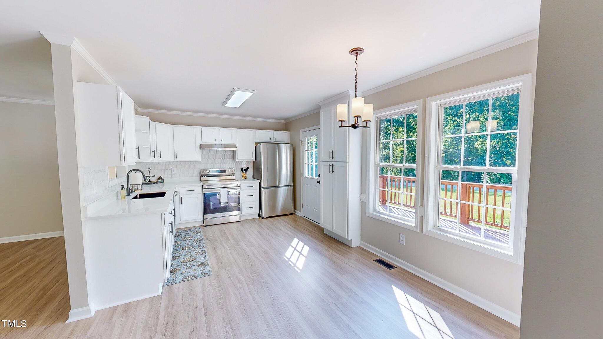 137 Dandelion Drive Timberlake, NC 27583 - Photo 2 of 53 a view of a kitchen with wooden floor electronic appliances and windows