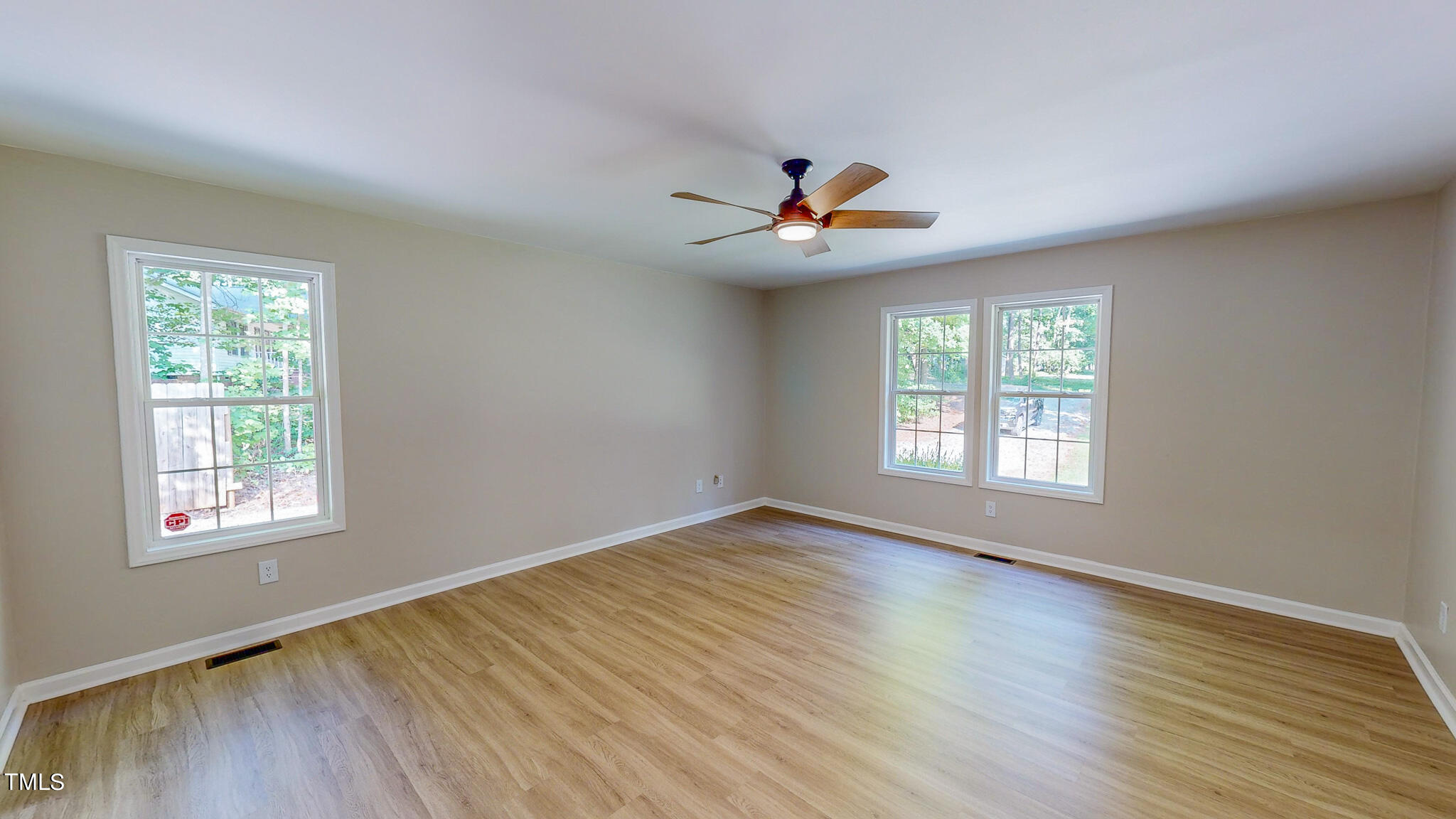 137 Dandelion Drive Timberlake, NC 27583 - Photo 23 of 53 a view of an empty room with a window and wooden floor