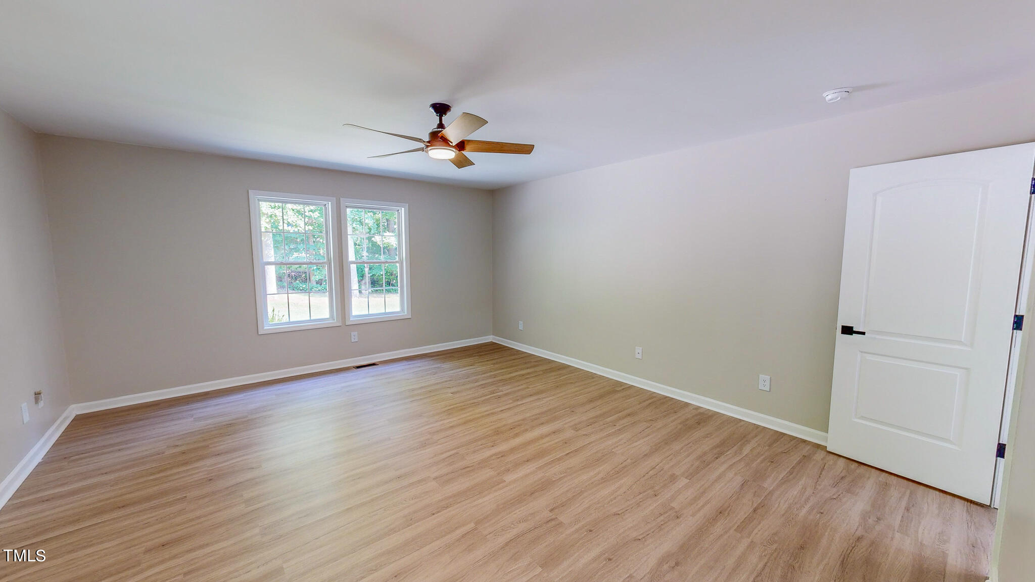 137 Dandelion Drive Timberlake, NC 27583 - Photo 30 of 53 an empty room with wooden floor and windows