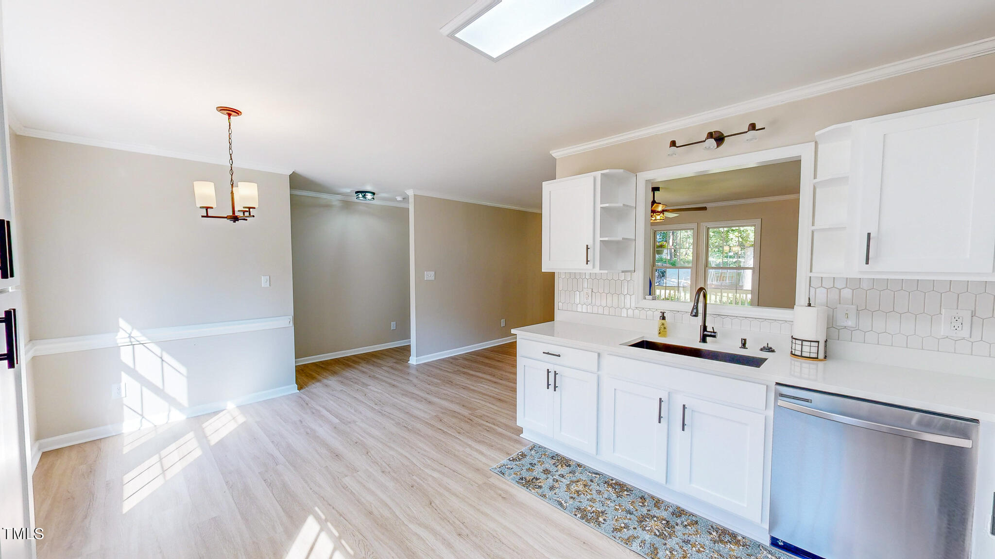 137 Dandelion Drive Timberlake, NC 27583 - Photo 3 of 53 a kitchen with granite countertop a sink and cabinets
