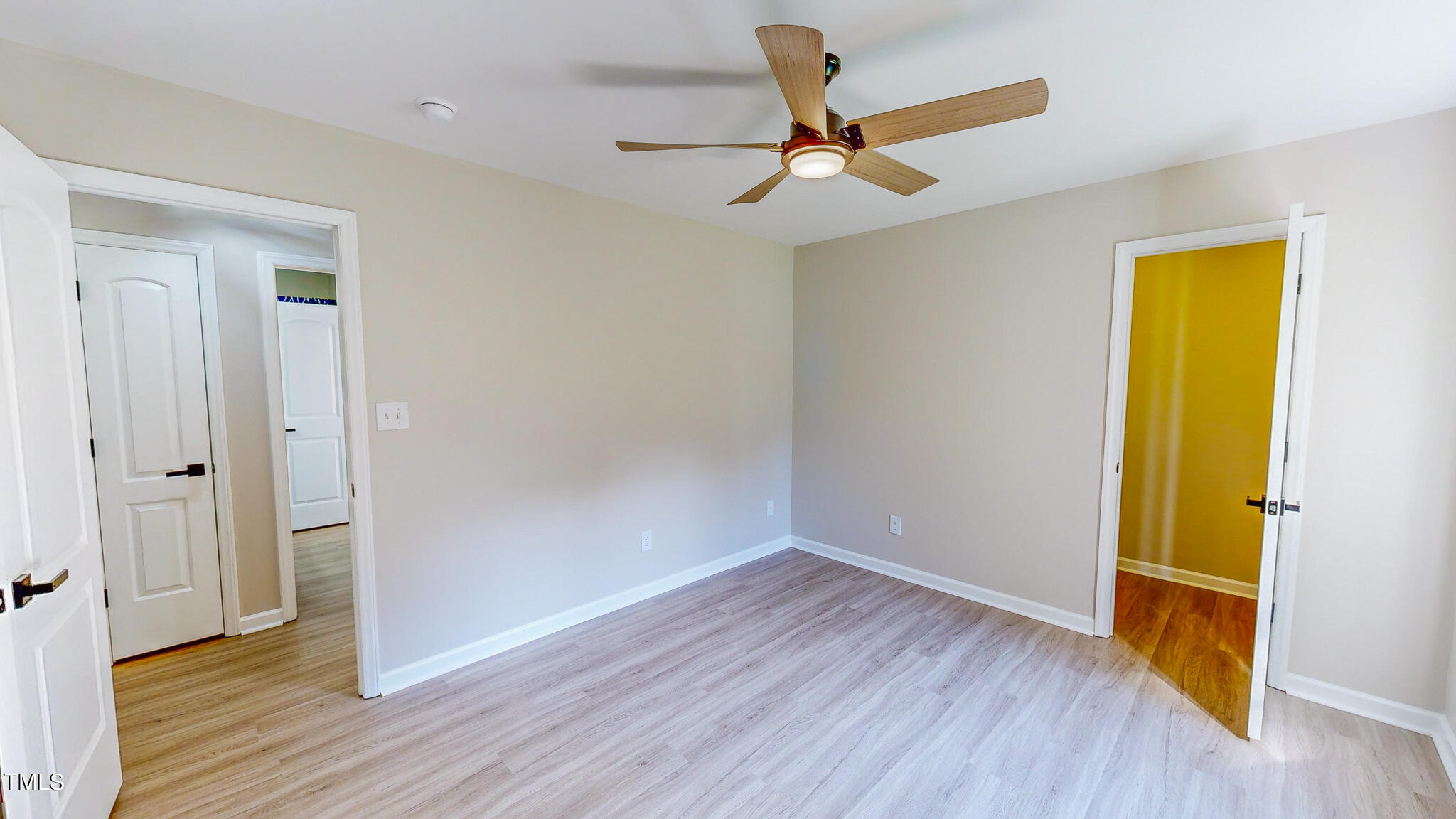 137 Dandelion Drive Timberlake, NC 27583 - Photo 35 of 53 a view of a room with wooden floor a ceiling fan and windows