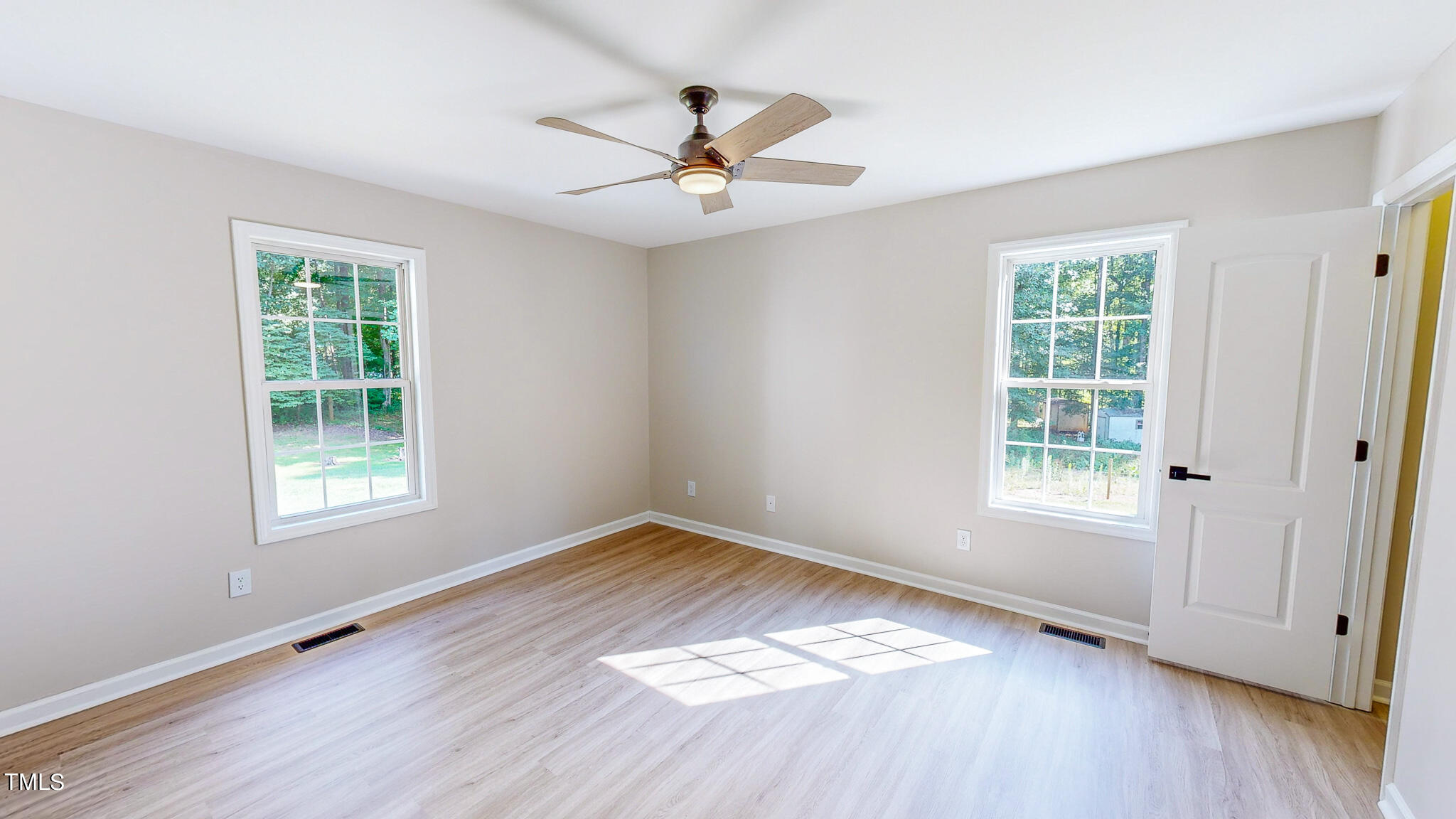137 Dandelion Drive Timberlake, NC 27583 - Photo 36 of 53 a view of an empty room with wooden floor and a window