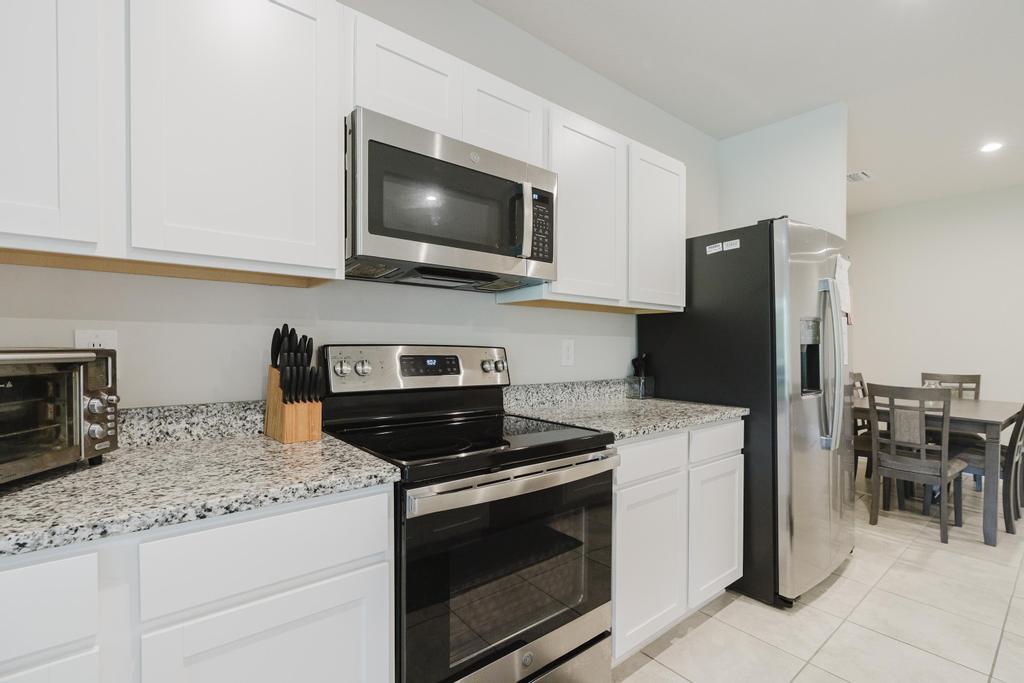252 Raspberry Road Fort Pierce, FL 34981 - Photo 11 of 66 a kitchen with granite countertop appliances and cabinets
