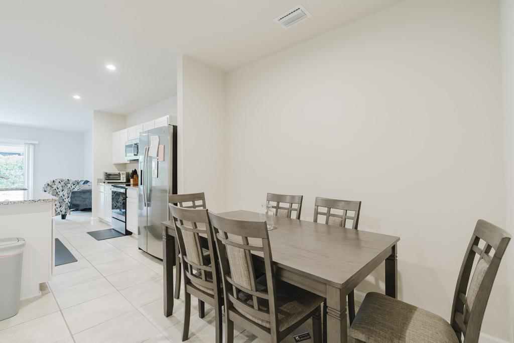 252 Raspberry Road Fort Pierce, FL 34981 - Photo 15 of 66 a view of a dining room with furniture