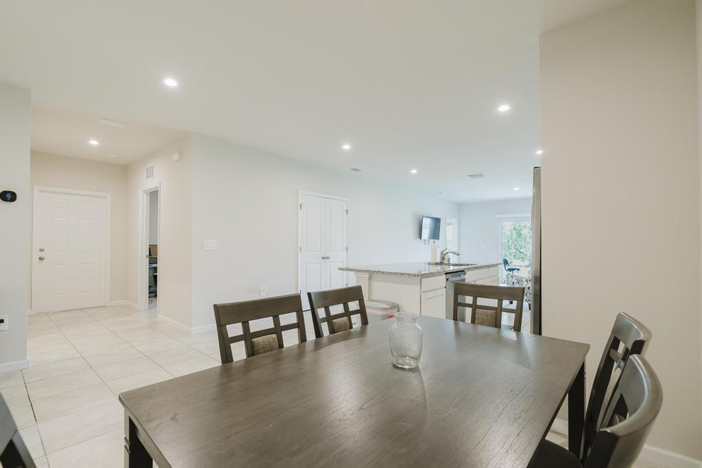 252 Raspberry Road Fort Pierce, FL 34981 - Photo 16 of 66 a view of kitchen with dining table and chairs