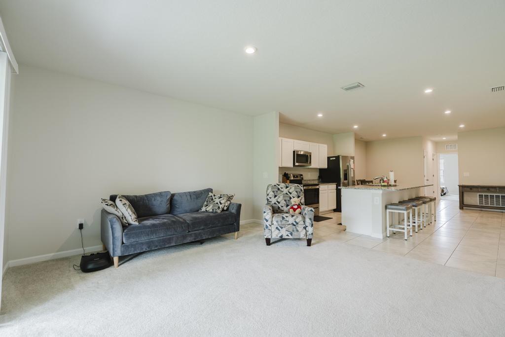 252 Raspberry Road Fort Pierce, FL 34981 - Photo 19 of 66 a living room with furniture and kitchen view