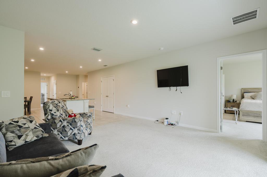 252 Raspberry Road Fort Pierce, FL 34981 - Photo 20 of 66 a living room with furniture and a flat screen tv