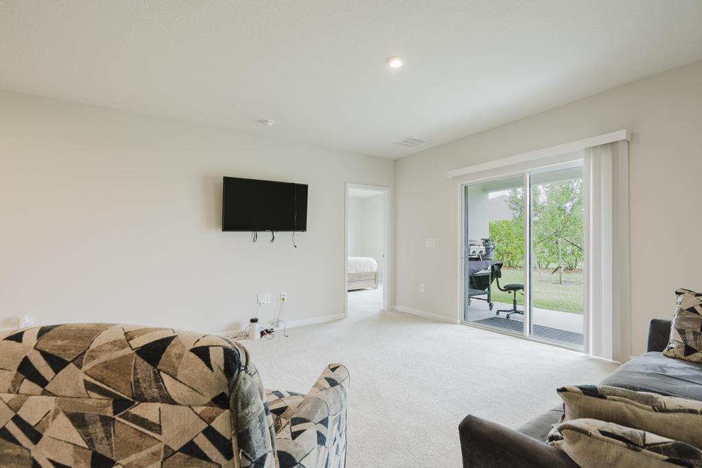 252 Raspberry Road Fort Pierce, FL 34981 - Photo 21 of 66 a living room with furniture and a flat screen tv