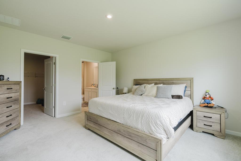 252 Raspberry Road Fort Pierce, FL 34981 - Photo 23 of 66 a bedroom with a bed and a dresser