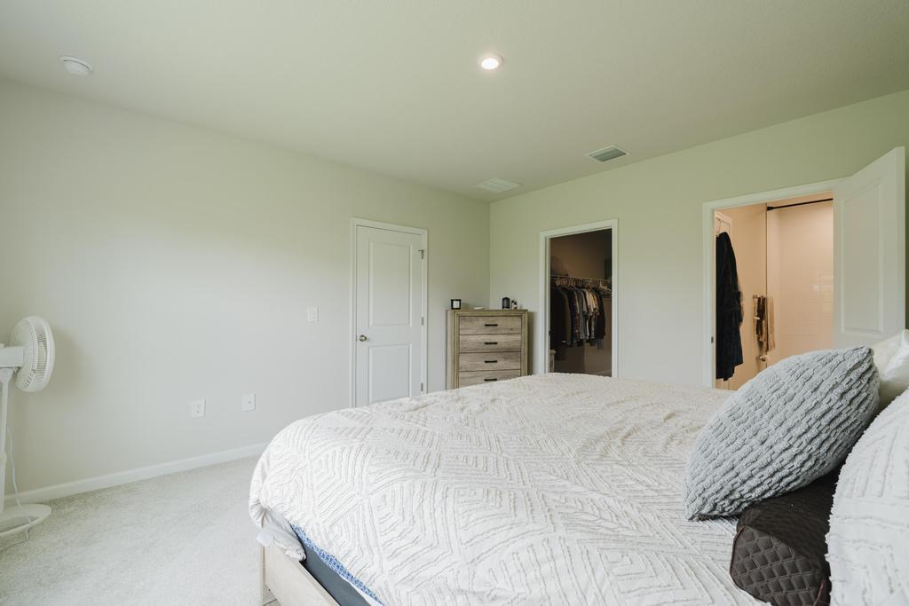 252 Raspberry Road Fort Pierce, FL 34981 - Photo 24 of 66 a bedroom with a bed and a dresser