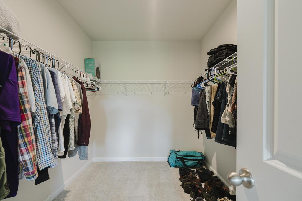 252 Raspberry Road Fort Pierce, FL 34981 - Photo 25 of 66 a view of walk in closet with clothes and shoes