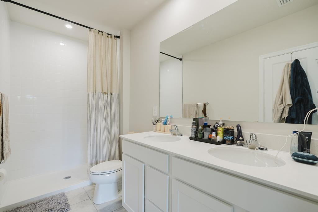 252 Raspberry Road Fort Pierce, FL 34981 - Photo 27 of 66 a bathroom with a sink a toilet and a mirror