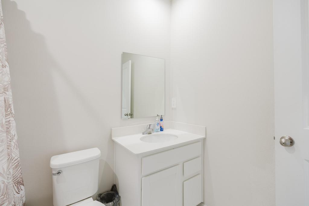 252 Raspberry Road Fort Pierce, FL 34981 - Photo 33 of 66 a bathroom with a sink a toilet and a mirror