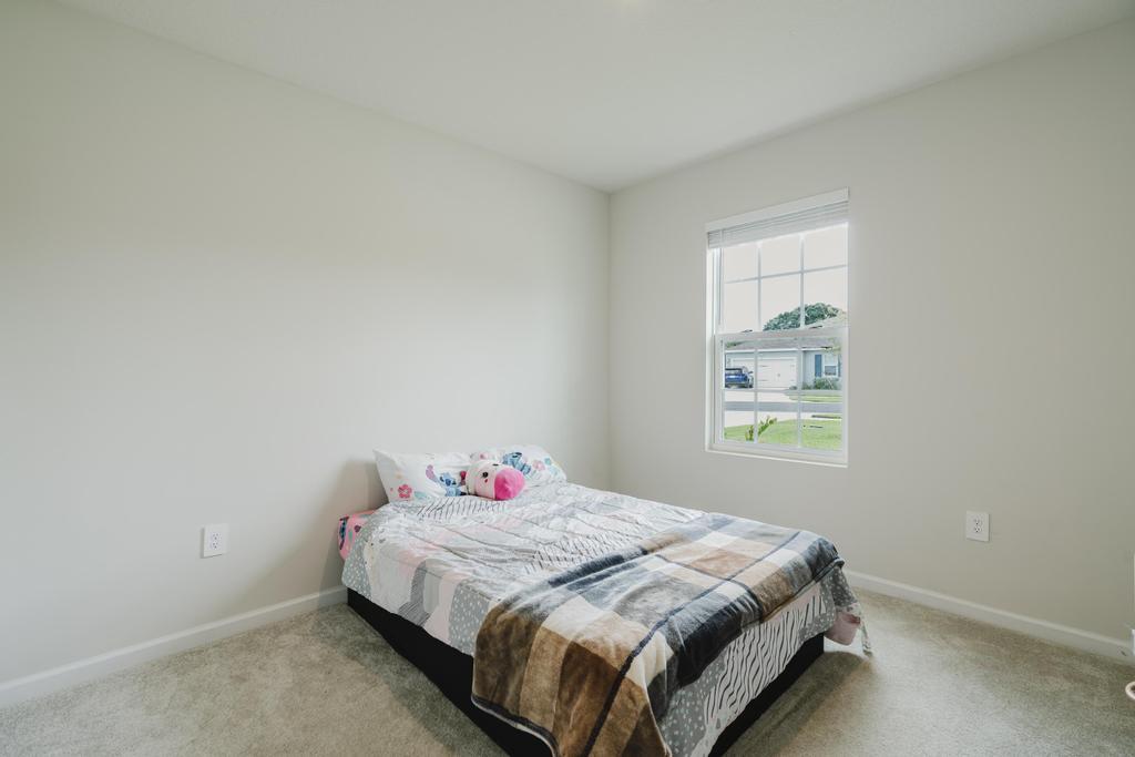 252 Raspberry Road Fort Pierce, FL 34981 - Photo 34 of 66 a bedroom with a bed and a window