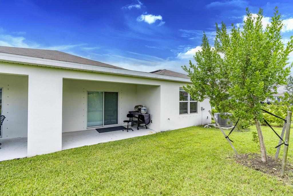 252 Raspberry Road Fort Pierce, FL 34981 - Photo 39 of 66 a view of a backyard with a patio