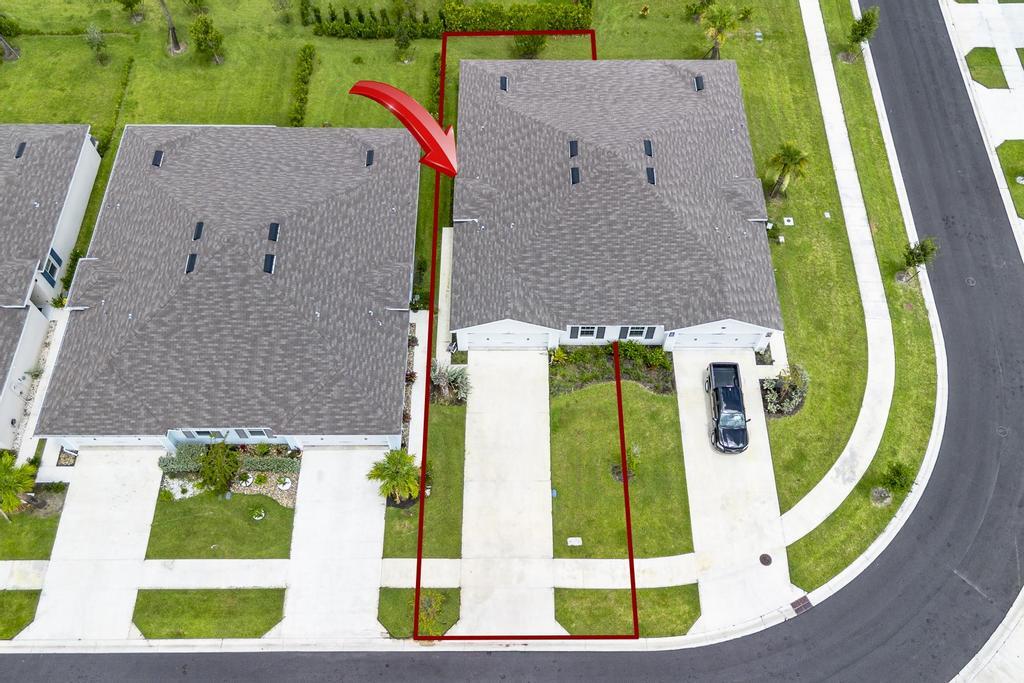 252 Raspberry Road Fort Pierce, FL 34981 - Photo 44 of 66 an aerial view of a house with a swimming pool