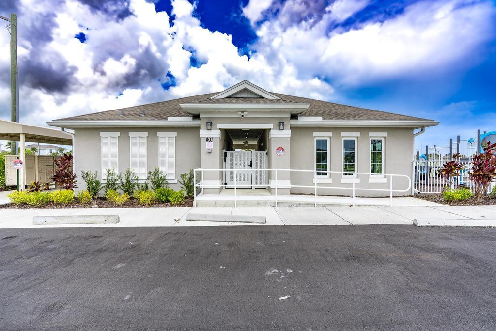 252 Raspberry Road Fort Pierce, FL 34981 - Photo 50 of 66 a front view of a house with a garden and yard