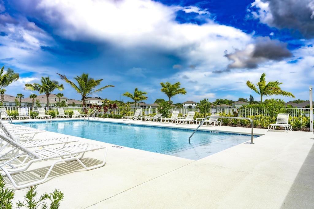 252 Raspberry Road Fort Pierce, FL 34981 - Photo 53 of 66 a view of a swimming pool with an outdoor space and seating area
