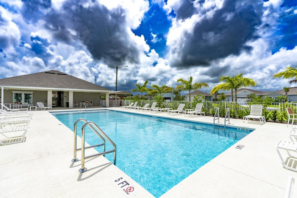 252 Raspberry Road Fort Pierce, FL 34981 - Photo 55 of 66 a view of swimming pool with outdoor seating and a garden