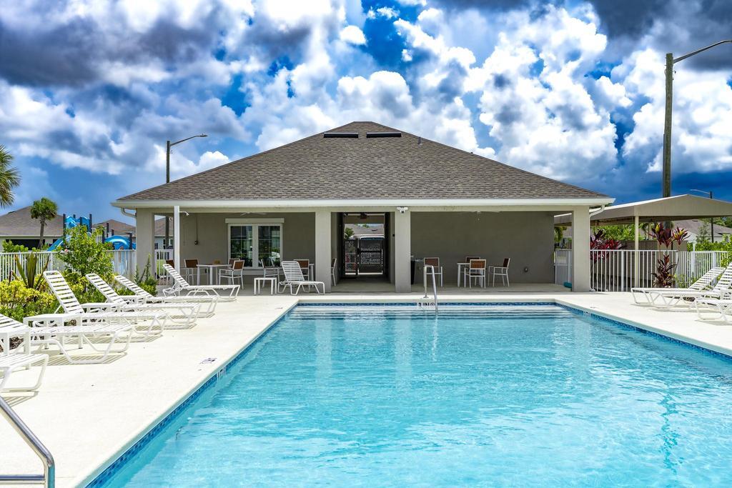 252 Raspberry Road Fort Pierce, FL 34981 - Photo 56 of 66 a view of a house with swimming pool and a porch with furniture