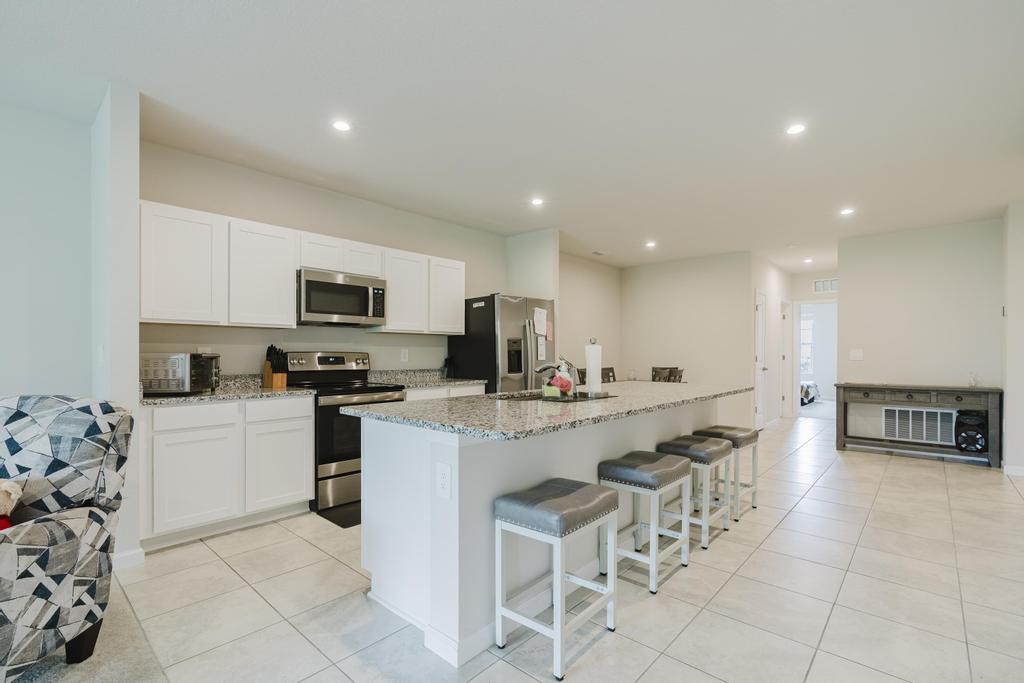 252 Raspberry Road Fort Pierce, FL 34981 - Photo 9 of 66 a kitchen with appliances a sink a counter top space and cabinets