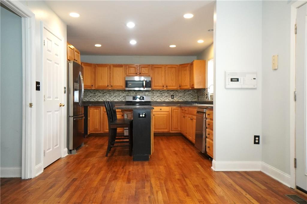 728 Mercer Street Pittsburgh, PA 15219 - Photo 8 of 27 a kitchen with stainless steel appliances granite countertop a stove and a refrigerator