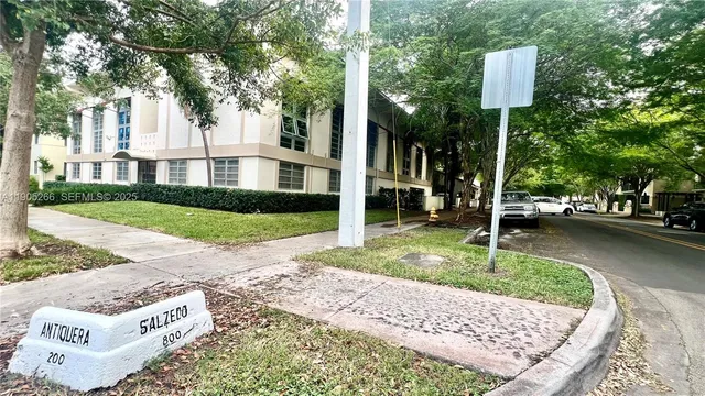 a view of a street with houses on the side of street