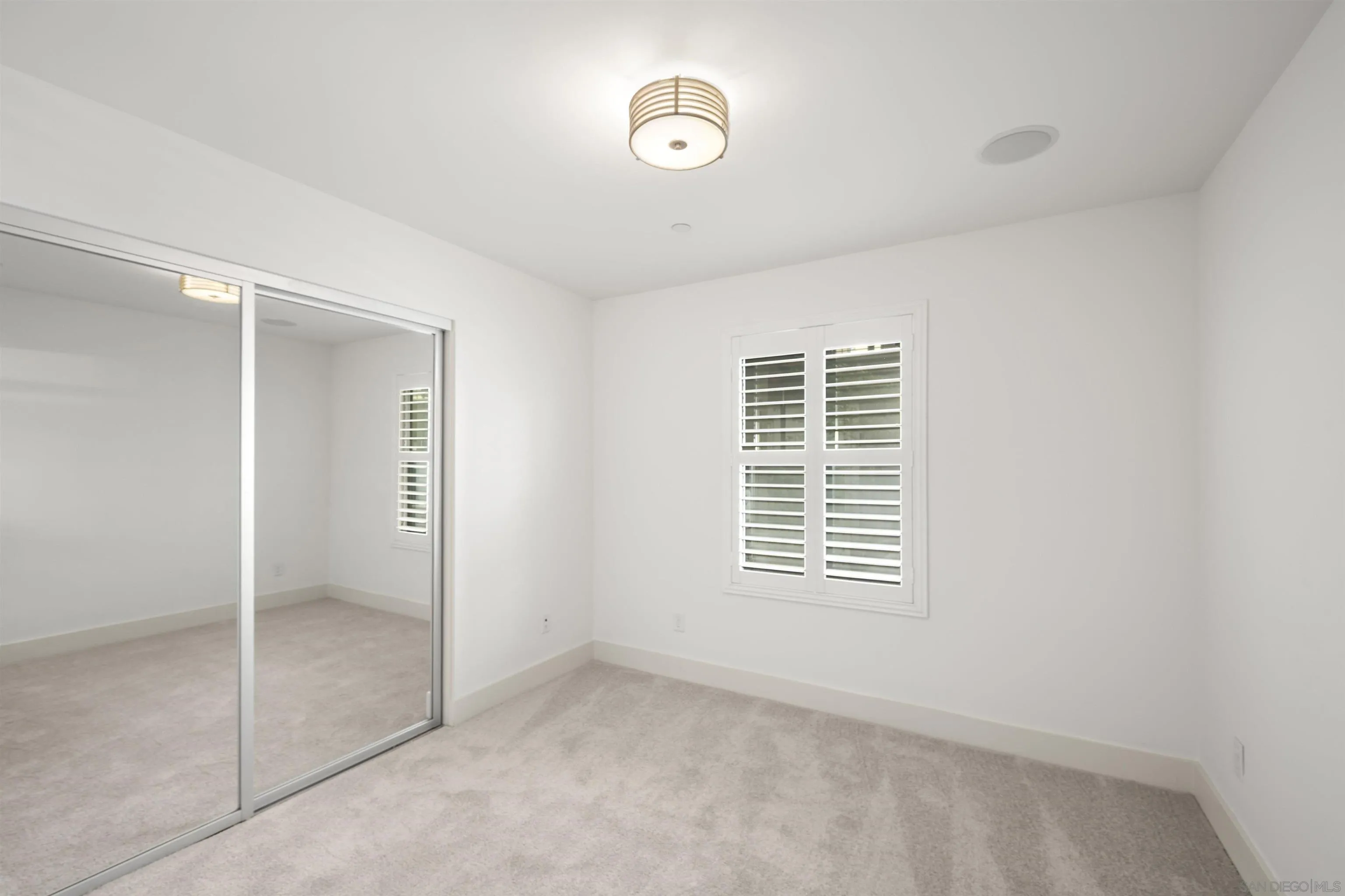 7853 Inception Way San Diego, CA 92108 - Photo 11 of 66 a view of an empty room with closet and a window