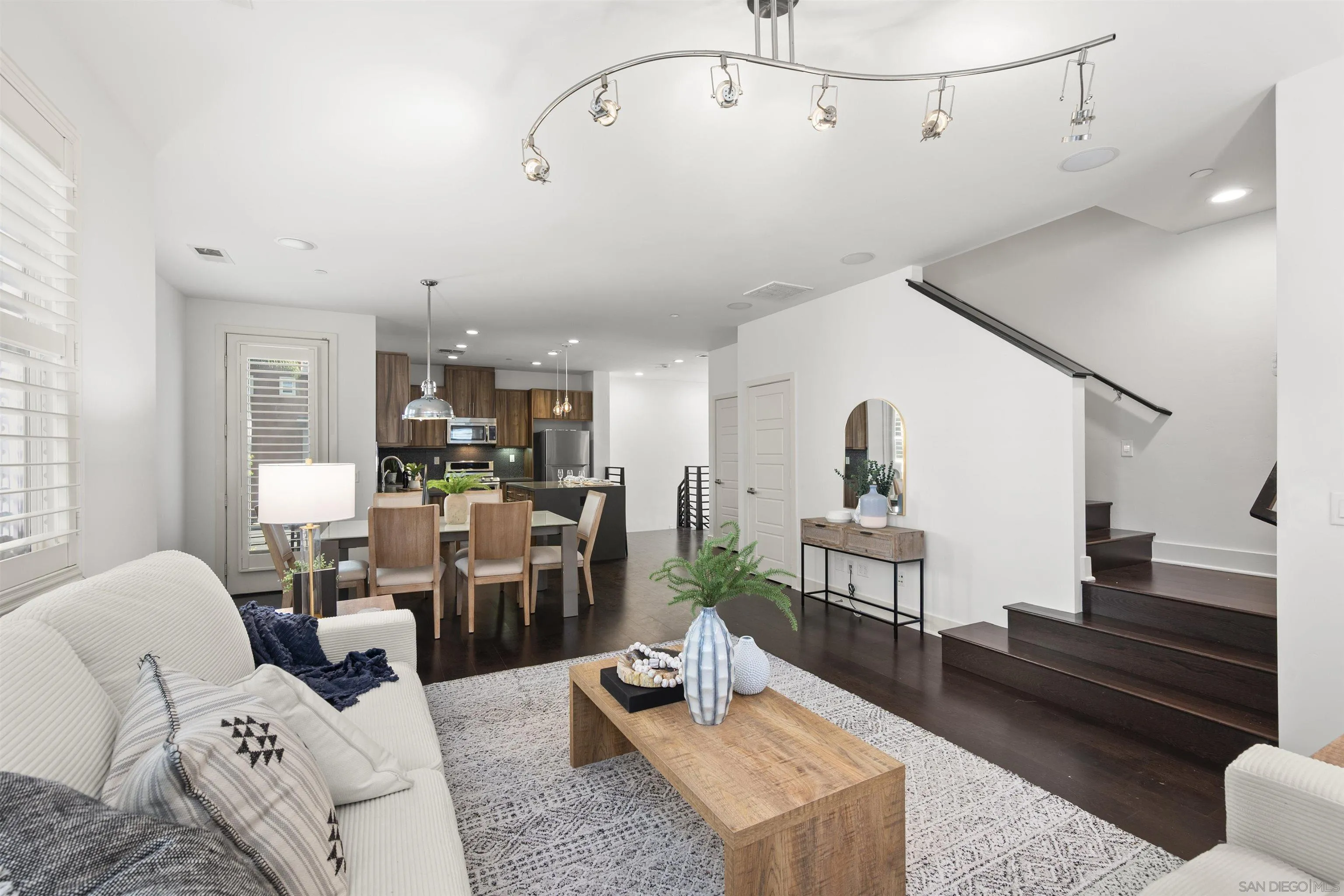 7853 Inception Way San Diego, CA 92108 - Photo 23 of 66 a living room with furniture and wooden floor