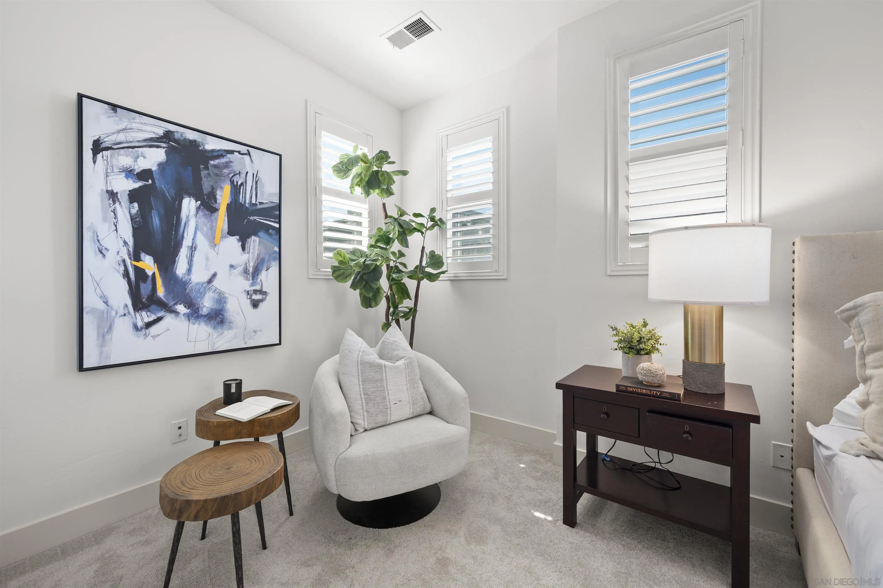 7853 Inception Way San Diego, CA 92108 - Photo 29 of 66 a living room with furniture a lamp potted plant and a lamp
