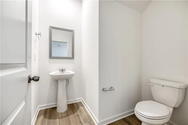 a white toilet sitting next to a sink