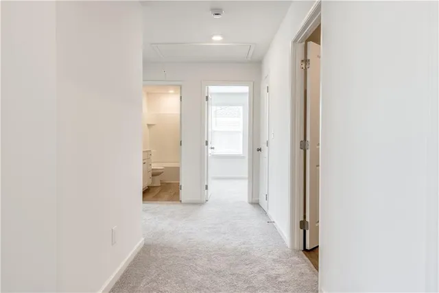 a view of a hallway with wooden shelves