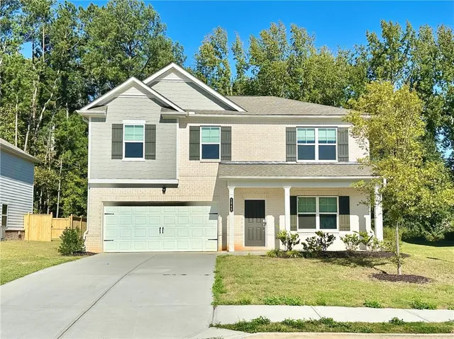 a front view of a house with a yard