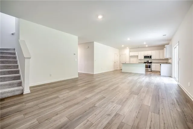 a view of kitchen with cabinets and wooden floor