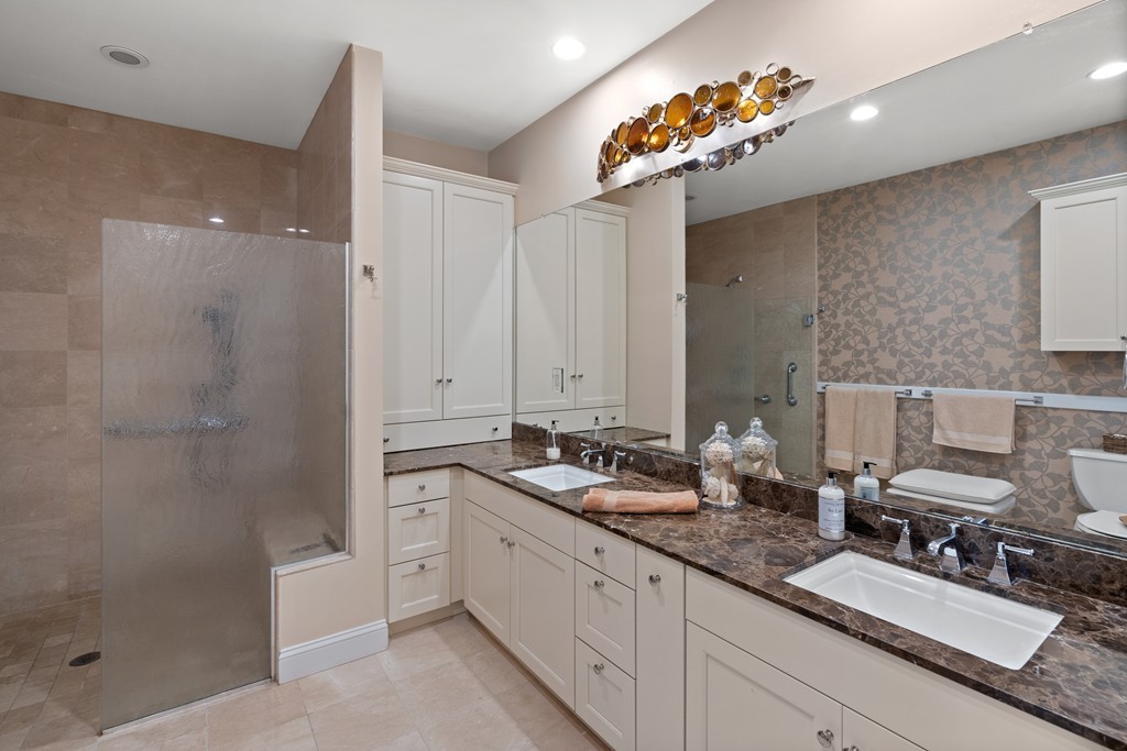 21 South Cottage Road, Unit 21 Belmont, MA 02478 - Photo 14 of 27 a bath room with a sink double vanity granite tub shower and a mirror