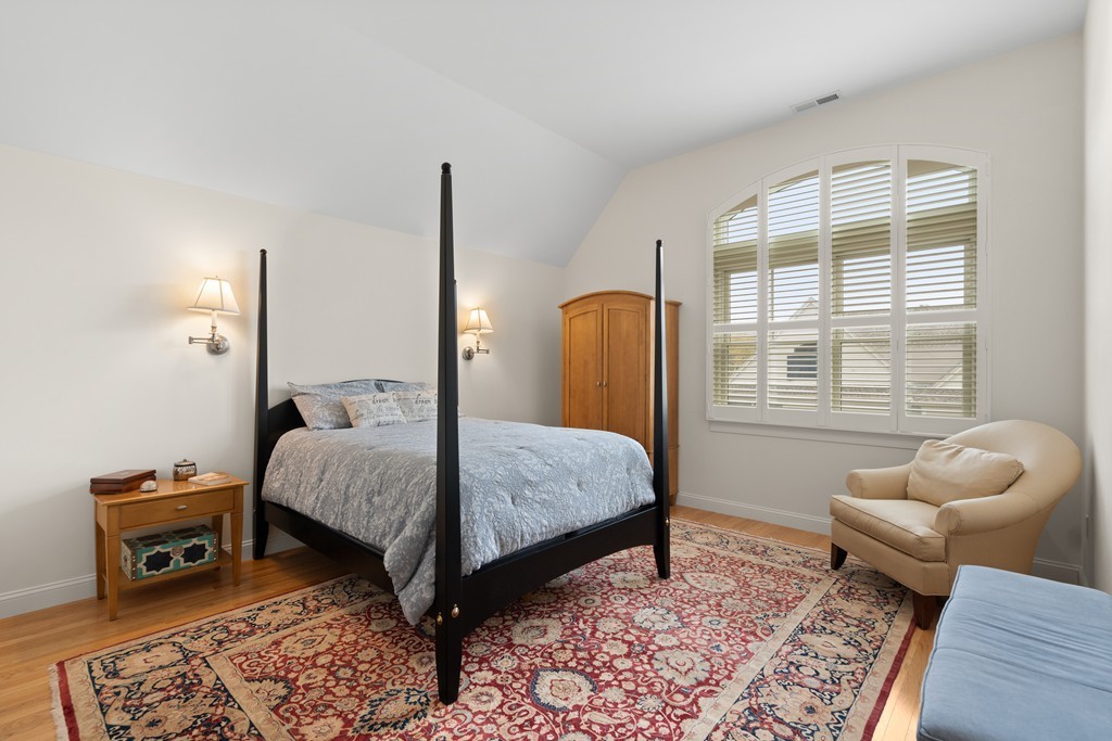 21 South Cottage Road, Unit 21 Belmont, MA 02478 - Photo 15 of 27 a bedroom with a bed and wooden floor