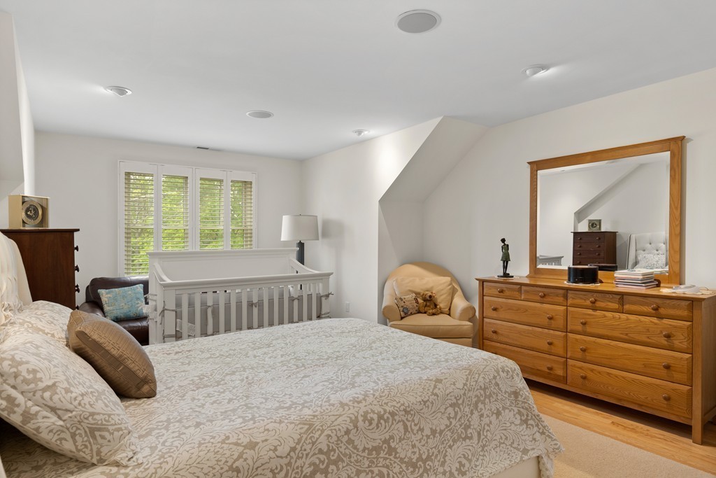 21 South Cottage Road, Unit 21 Belmont, MA 02478 - Photo 16 of 27 a bedroom with a bed and a dresser