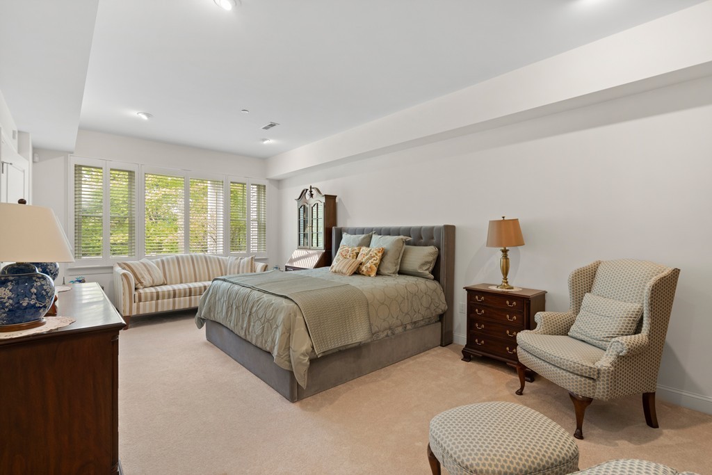 21 South Cottage Road, Unit 21 Belmont, MA 02478 - Photo 20 of 27 a spacious bedroom with a bed and a large window