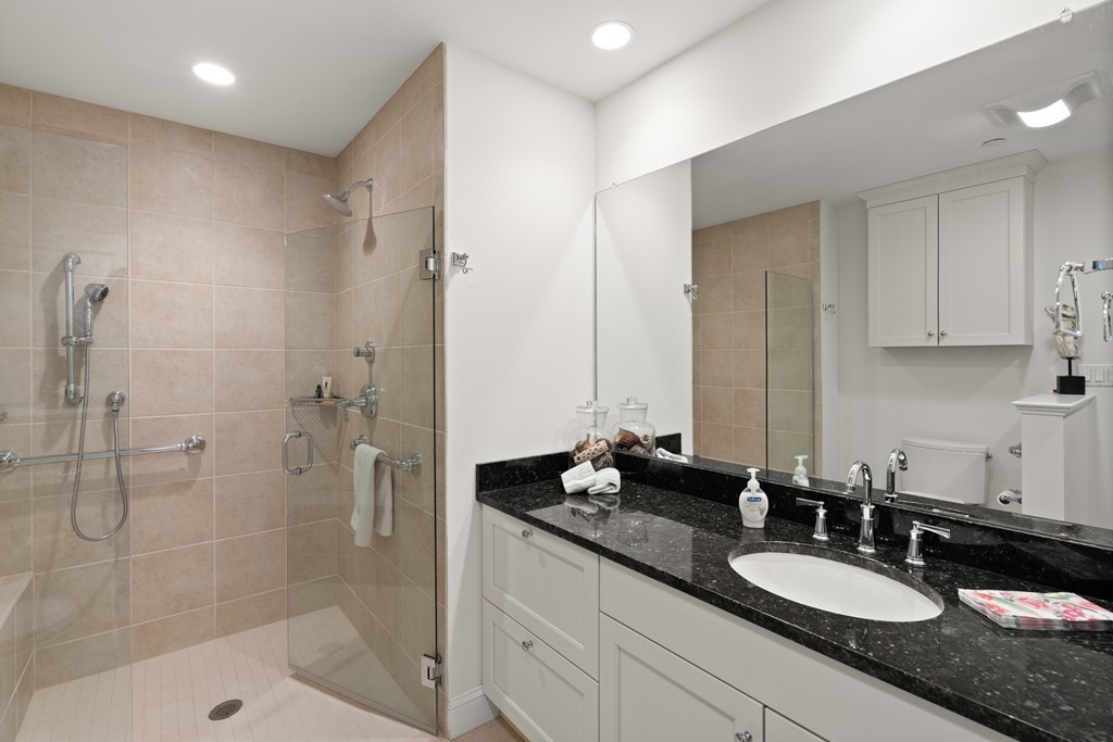 21 South Cottage Road, Unit 21 Belmont, MA 02478 - Photo 21 of 27 a bathroom with a granite countertop sink mirror and double