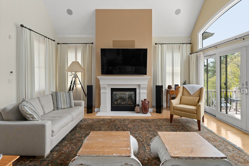 21 South Cottage Road, Unit 21 Belmont, MA 02478 - Photo 4 of 27 a living room with furniture a flat screen tv and a fireplace